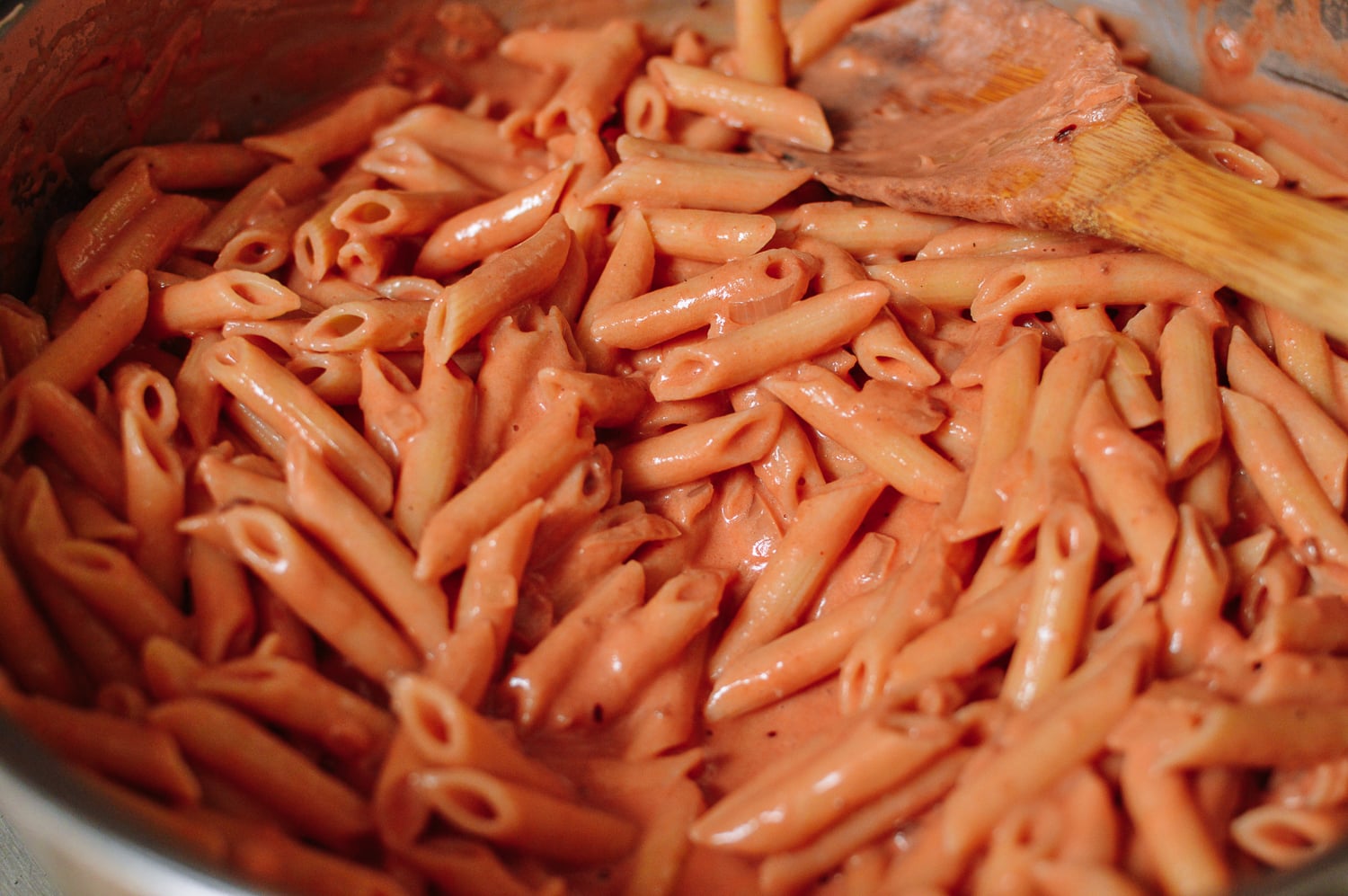 Stirring pasta into vodka sauce, thewoksoflife.com