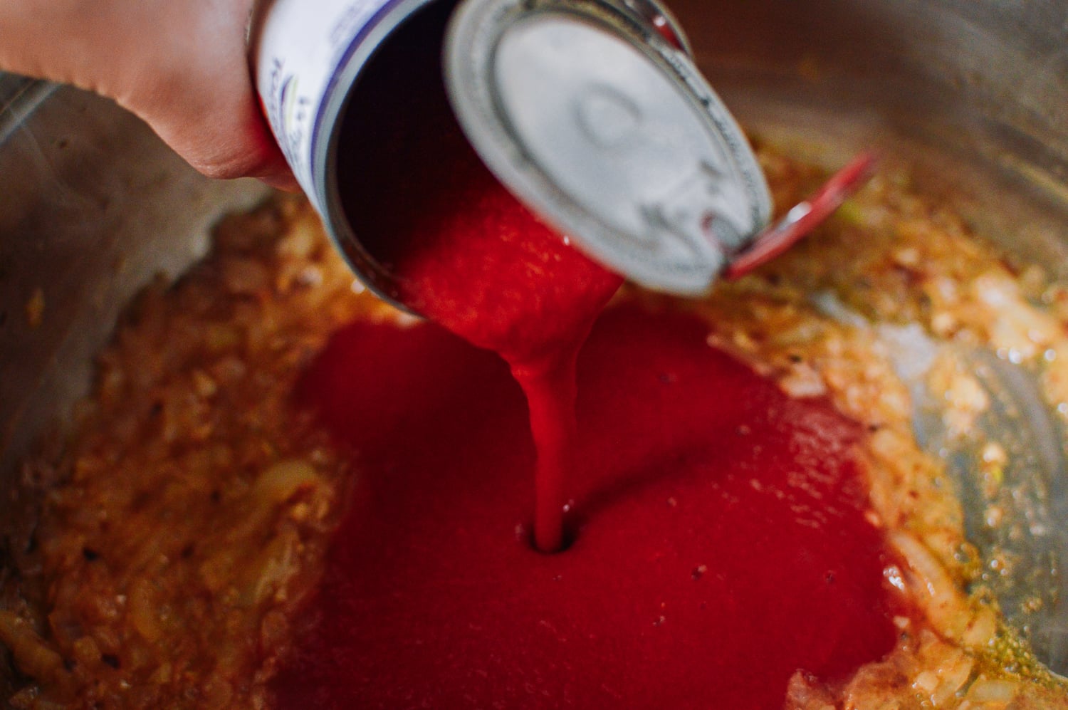 adding tomato puree to vodka sauce, thewoksoflife.com