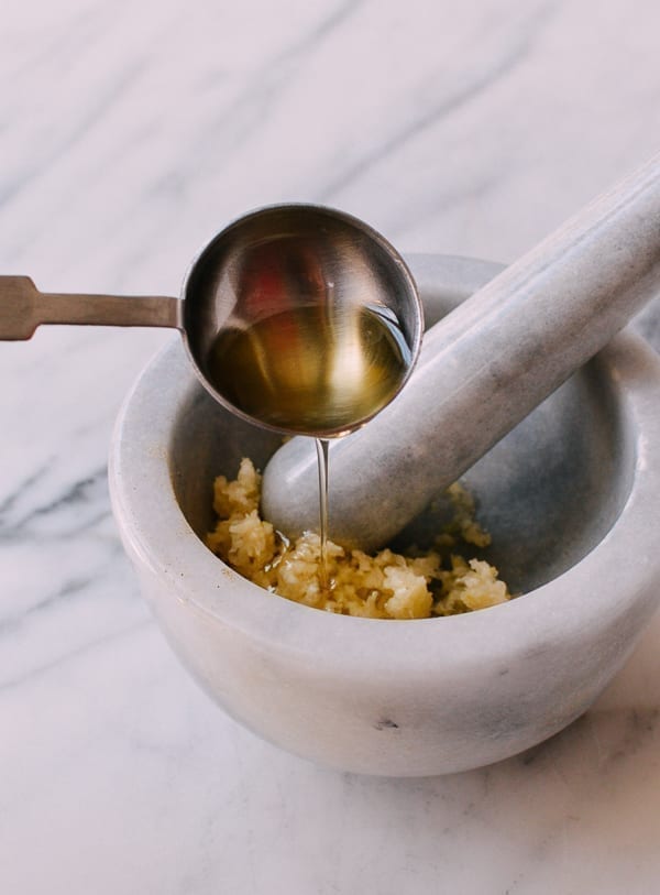 Mixing crushed garlic with olive oil, thewoksoflife.com