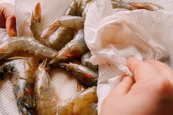 Patting shrimp dry with paper towel, thewoksoflife.com