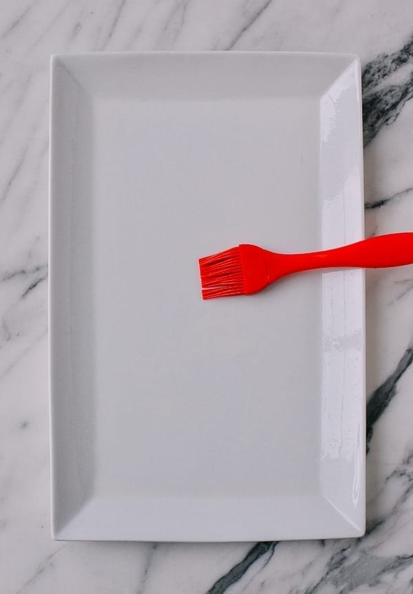 Brushing oil on plate, thewoksoflife.com