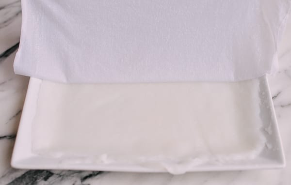 Removing cloth from rice noodle, thewoksoflife.com