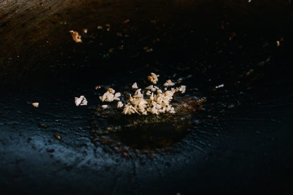 Garlic in oil in wok, thewoksoflife.com
