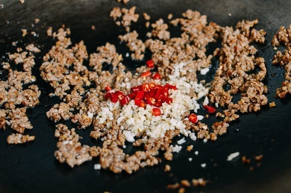 Adding red chilies, thewoksoflife.com