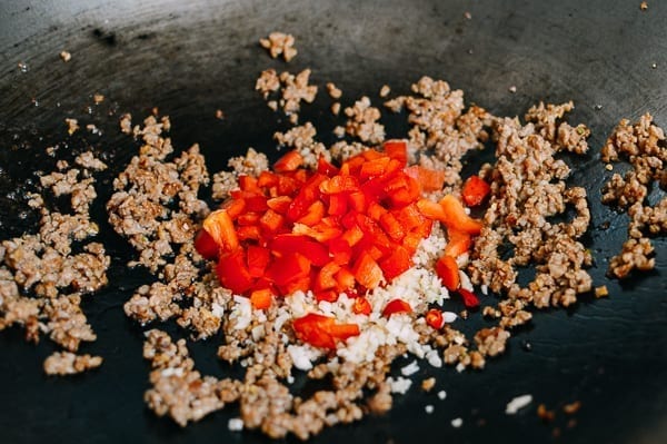 Adding red bell pepper, thewoksoflife.com