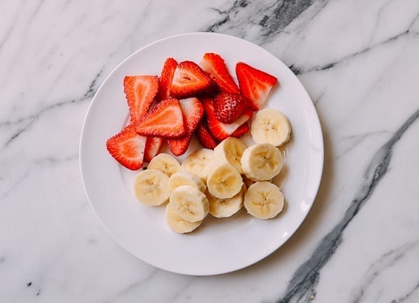 Sliced strawberries and bananas, thewoksoflife.com