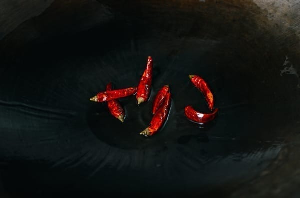 Dried chili peppers in wok, thewoksoflife.com