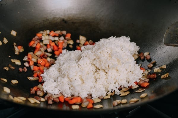Adding cooked rice to wok, thewoksoflife.com