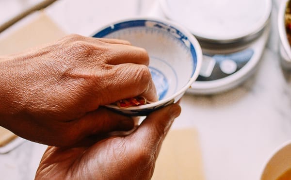 Squeezing egg roll filling with hands, thewoksoflife.com