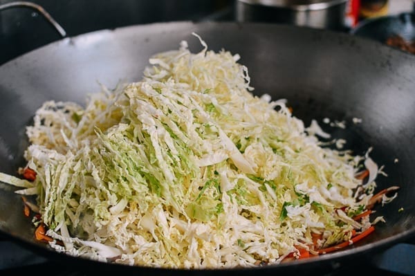 Adding cabbage to filling, thewoksoflife.com