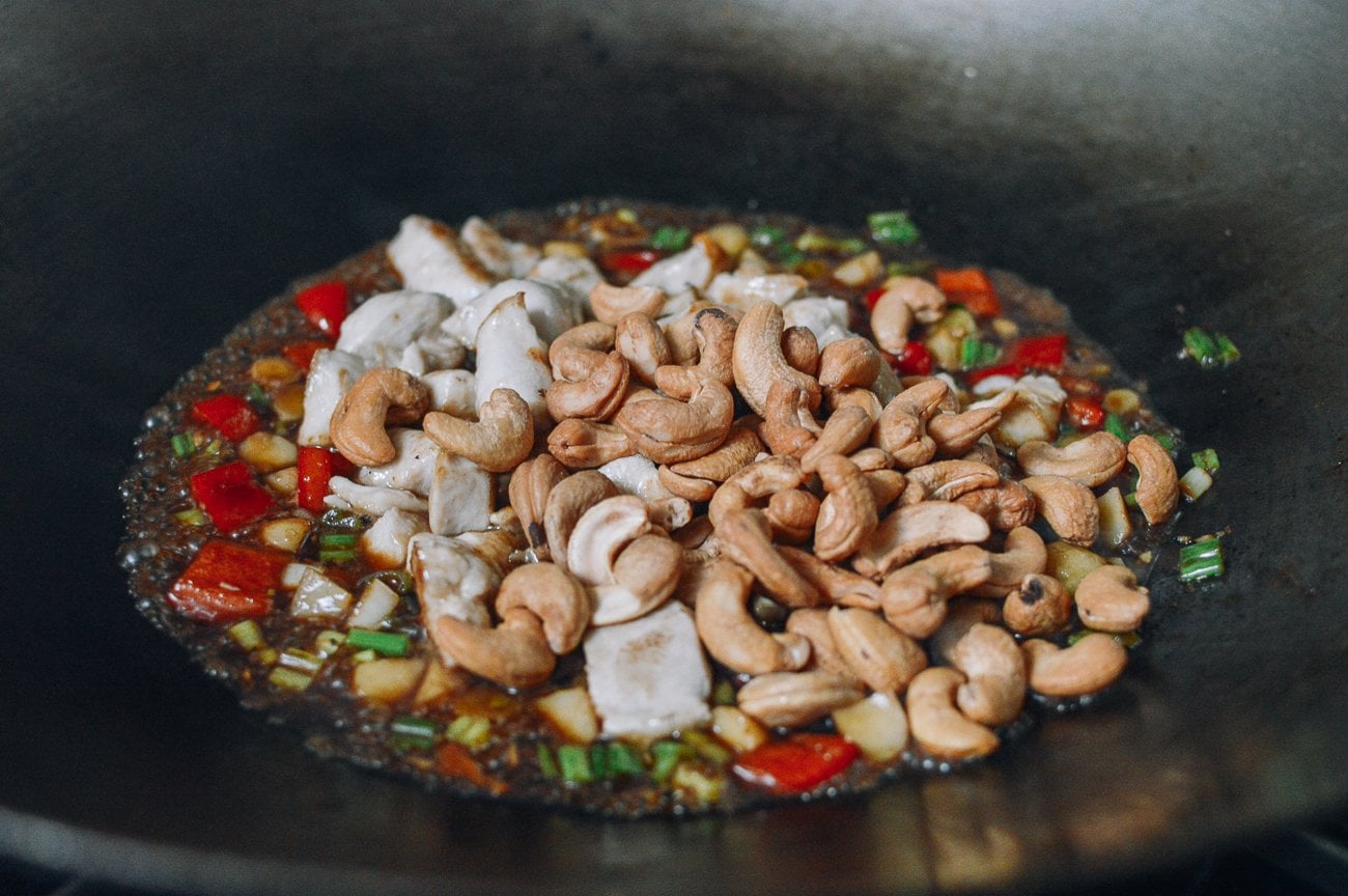 stirring cashews into chicken and vegetables