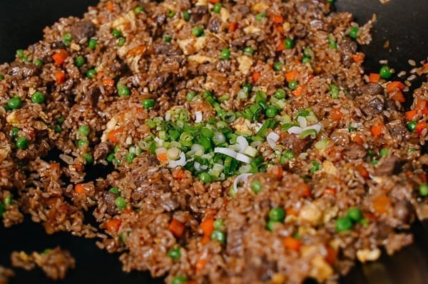 Adding scallions to fried rice at the end, thewoksoflife.com
