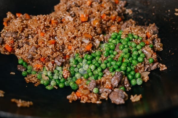 Adding frozen peas, thewoksoflife.com
