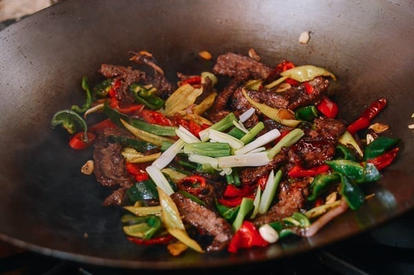Adding scallions at the end of the cooking process, thewoksoflife.com