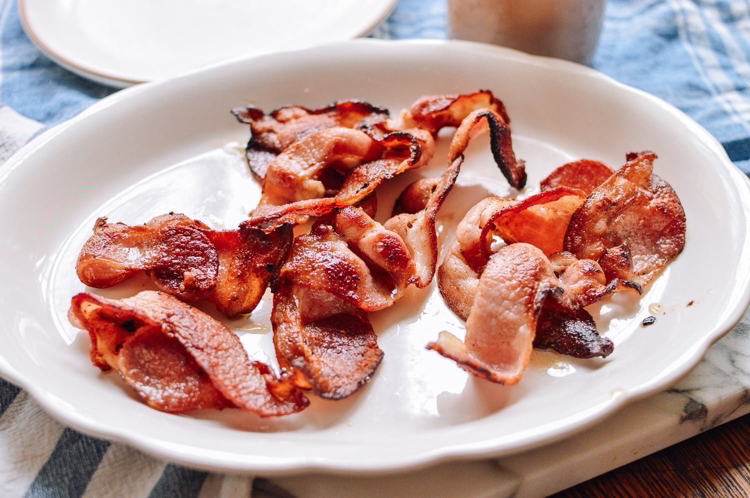 Cooked bacon on a plate, thewoksoflife.com