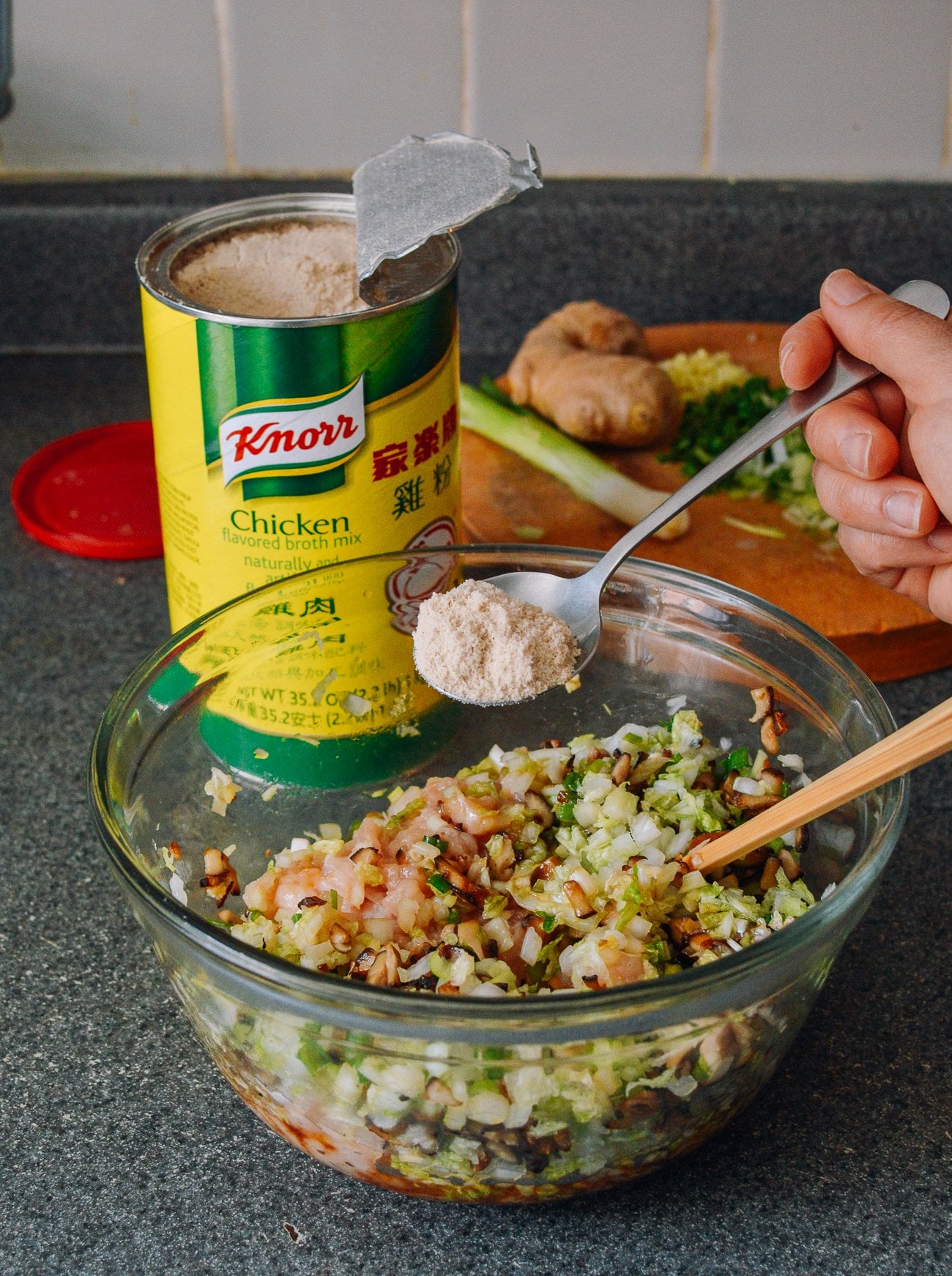 Adding chicken powder to chicken wonton filling mixture