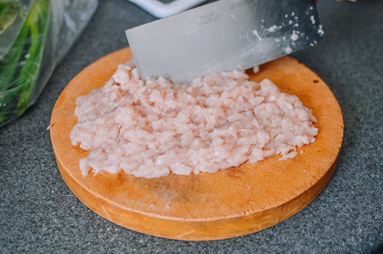 hand chopped ground chicken on cutting board