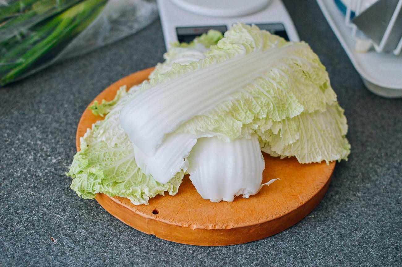 napa cabbage leaves on round cutting board