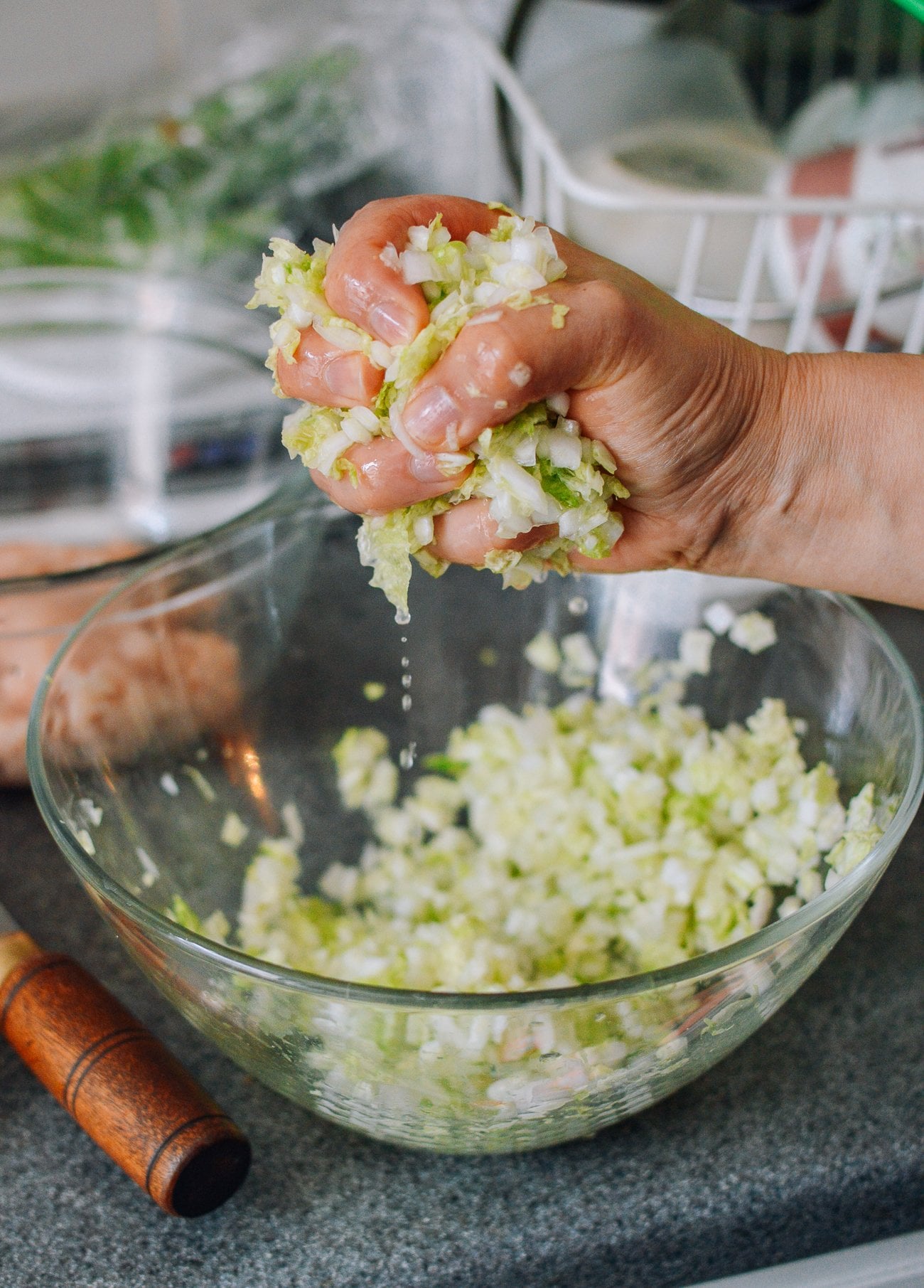 Squeezing water out of chopped, salted napa cabbage