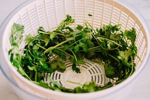 Cilantro in salad spinner, thewoksoflife.com