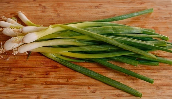 Scallions on cutting board, thewoksoflife.com