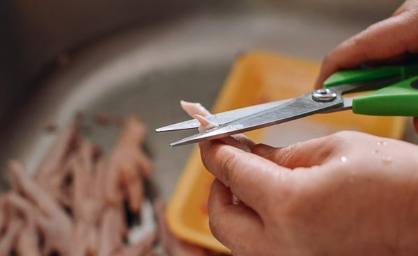 Trimming claws from chicken feet, thewoksoflife.com