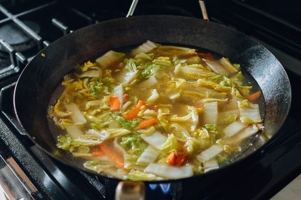 Adding chicken stock and water to make soup, thewoksoflife.com