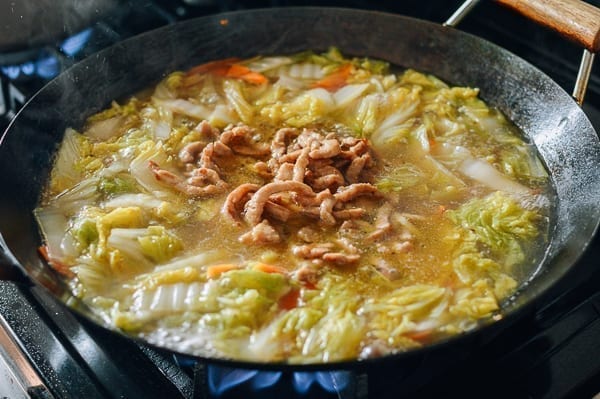 Stirring the pork into the soup, thewoksoflife.com