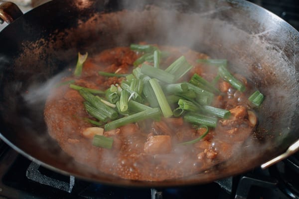 Adding green parts of the scallions, thewoksoflife.com