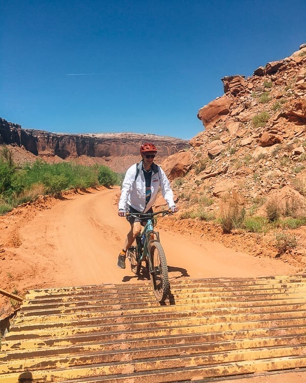 Lee - Mountain biking Moab over cattle grate by thewoksoflife.com