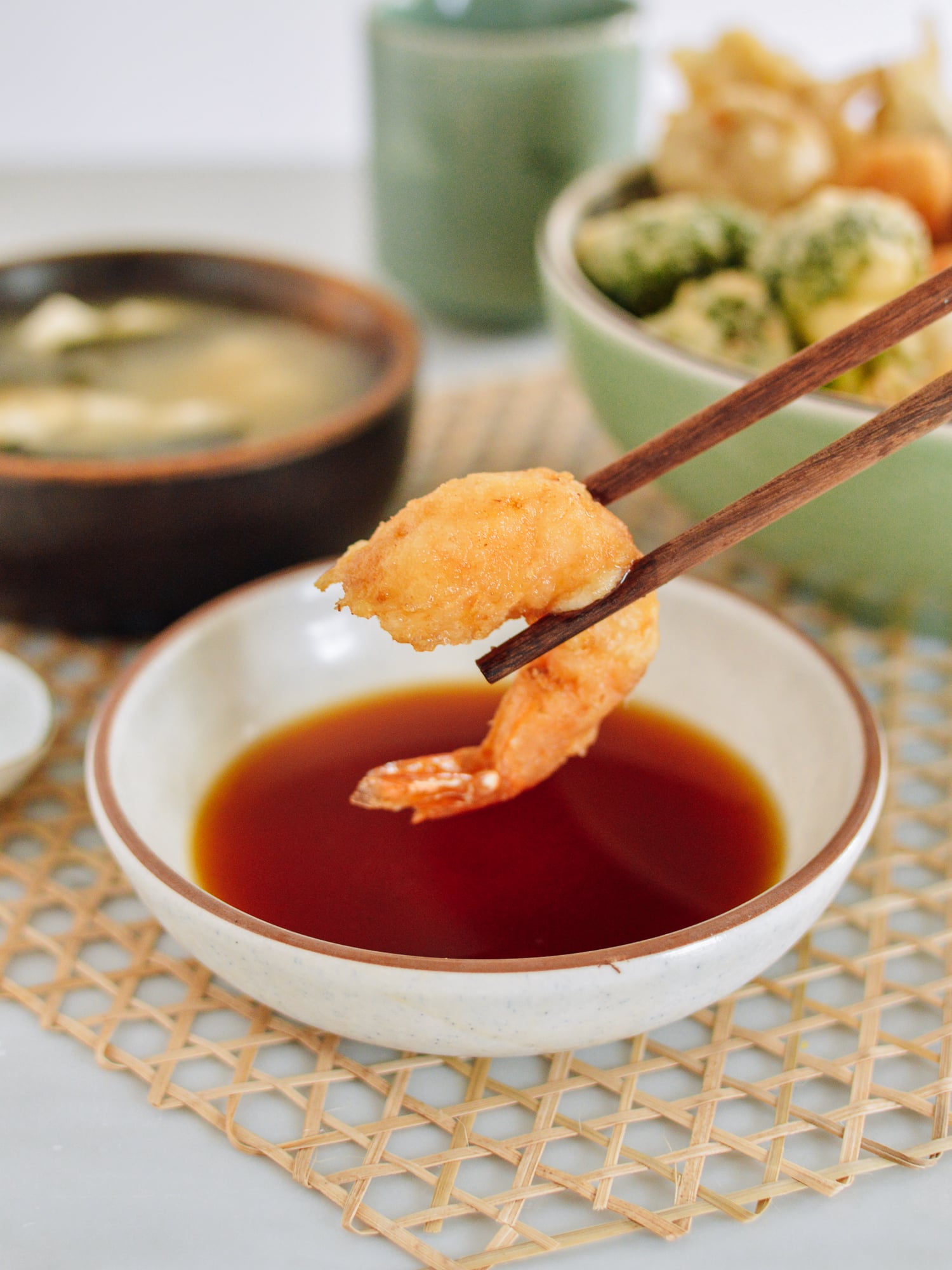 Dipping shrimp tempura into dipping sauce, thewoksoflife.com