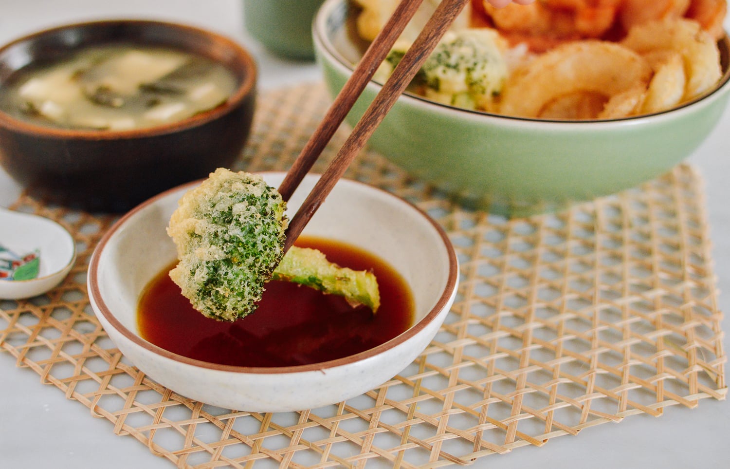 Dipping broccoli tempura into sauce, thewoksoflife.com