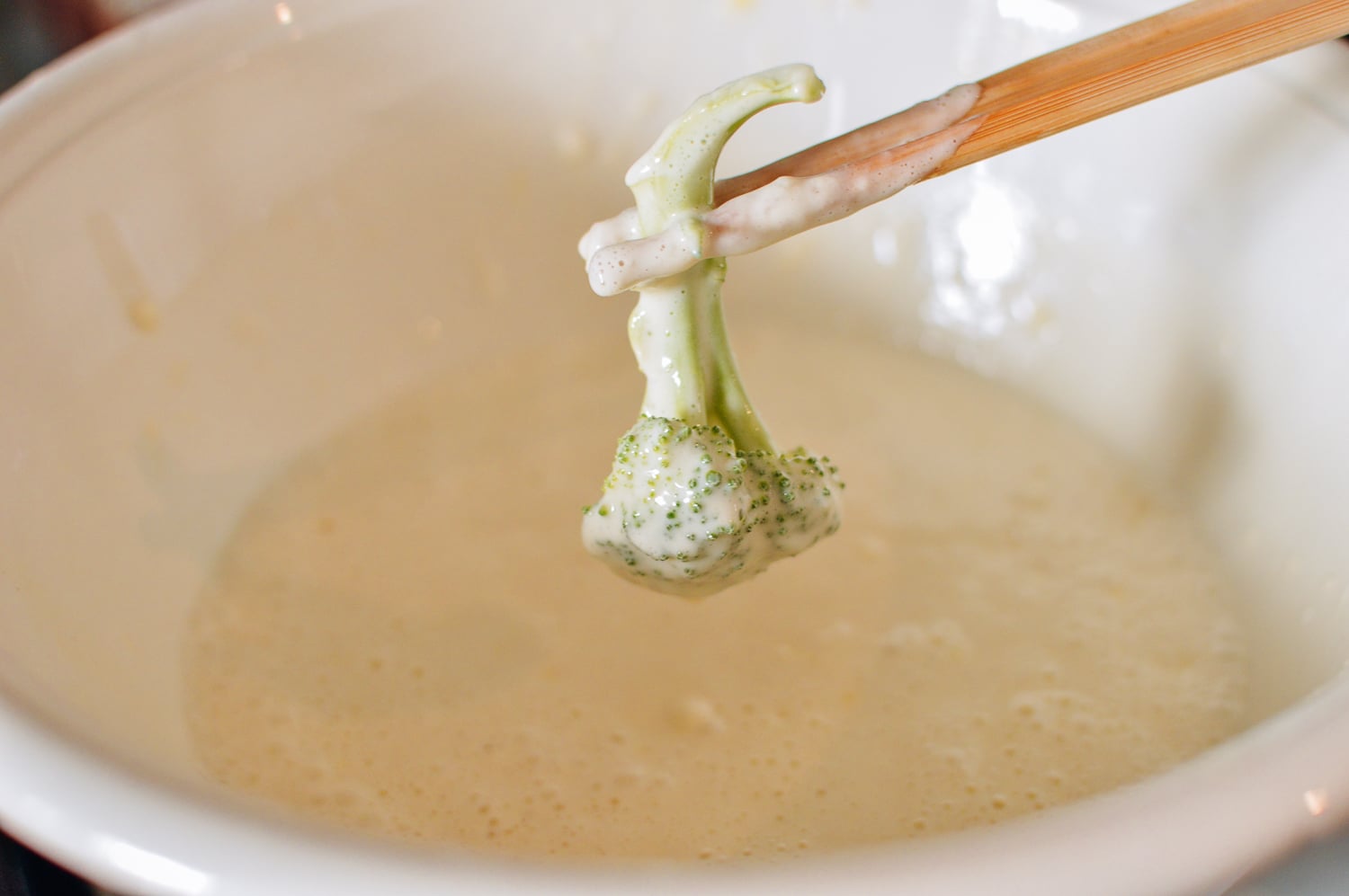 Dipping broccoli into tempura batter, thewoksoflife.com