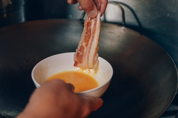 Dipping bacon wrapped shrimp into egg, thewoksoflife.com