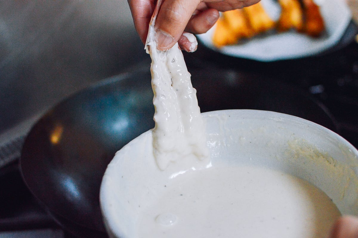 Dipping shrimp in batter, thewoksoflife.com