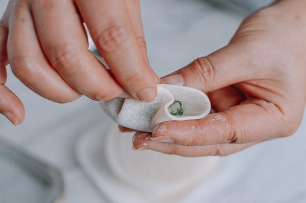 Pleating towards middle of dumpling, thewoksoflife.com