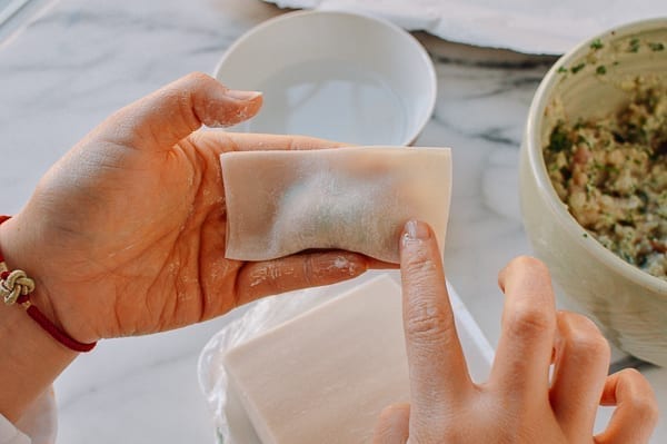 Dabbing corner of wonton wrapper with water, thewoksoflife.com