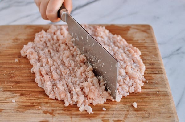 Grinding dark meat chicken by hand, thewoksoflife.com