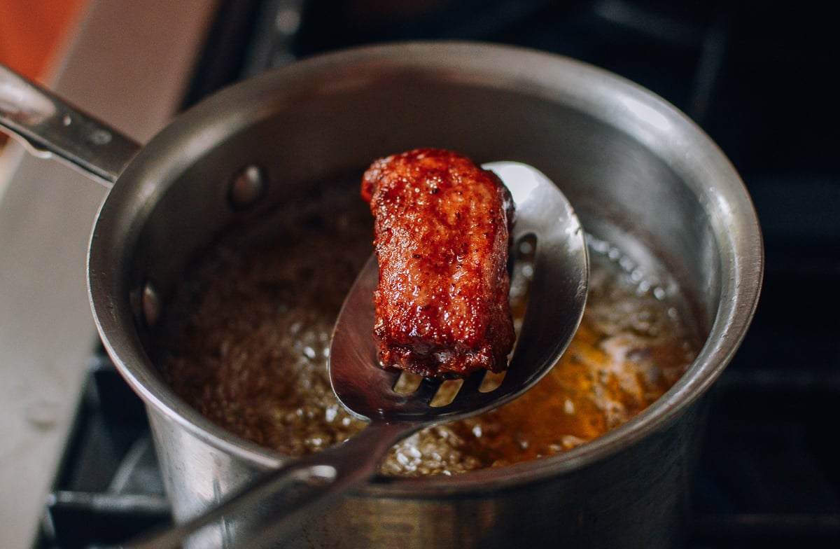 Pulling fried rib out of frying oil, thewoksoflife.com