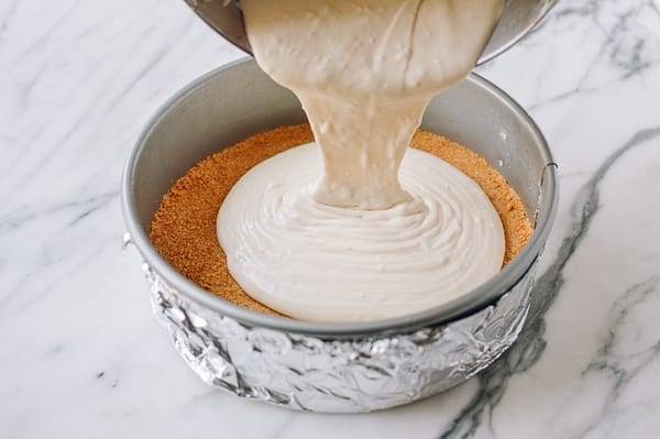 Pouring filling into prepared crust, thewoksoflife.com