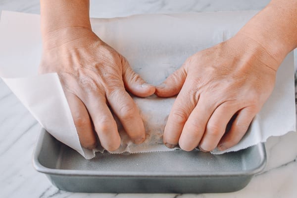 Shaping marshmallow treats in pan with parchment paper, thewoksoflife.com