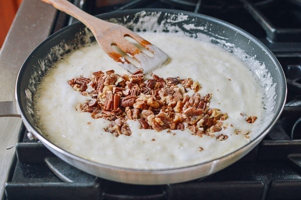 Adding toasted nuts to melted marshmallows, thewoksoflife.com