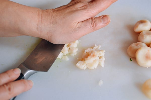 Smashing water chestnuts with knife, thewoksoflife.com