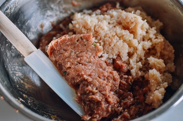 Adding minced water chestnuts to meat mixture, thewoksoflife.com