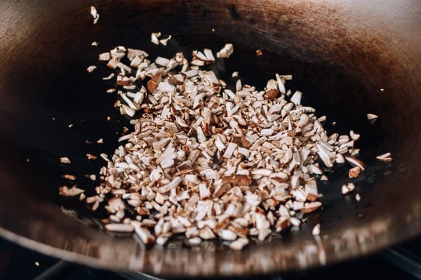 Cooking chopped mushrooms in wok, thewoksoflife.com