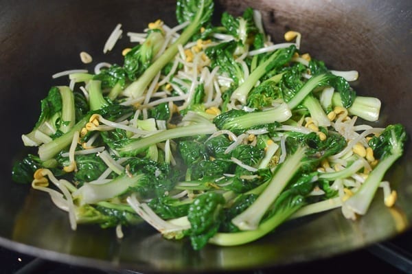 Ruyi cai being stir-fried in a wok, thewoksoflife.com