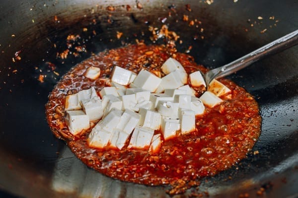 Adding tofu to sauce, thewoksoflife.com