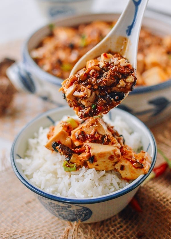 Spooning vegan mapo tofu over rice, thewoksoflife.com