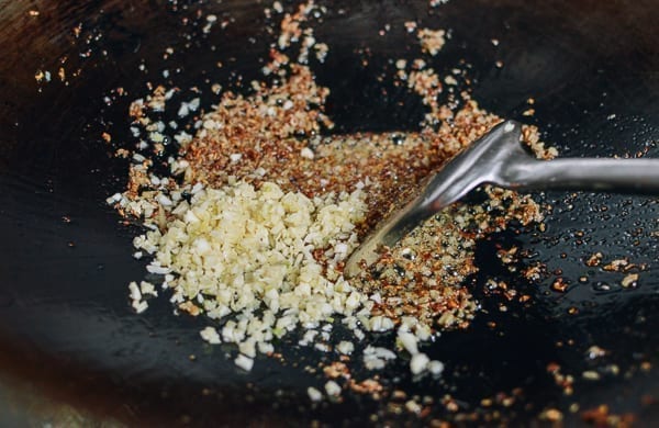 Adding chopped garlic, thewoksoflife.com