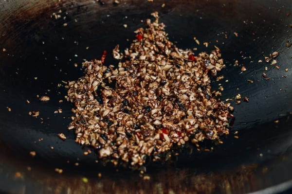 Caramelizing chopped mushrooms in wok, thewoksoflife.com